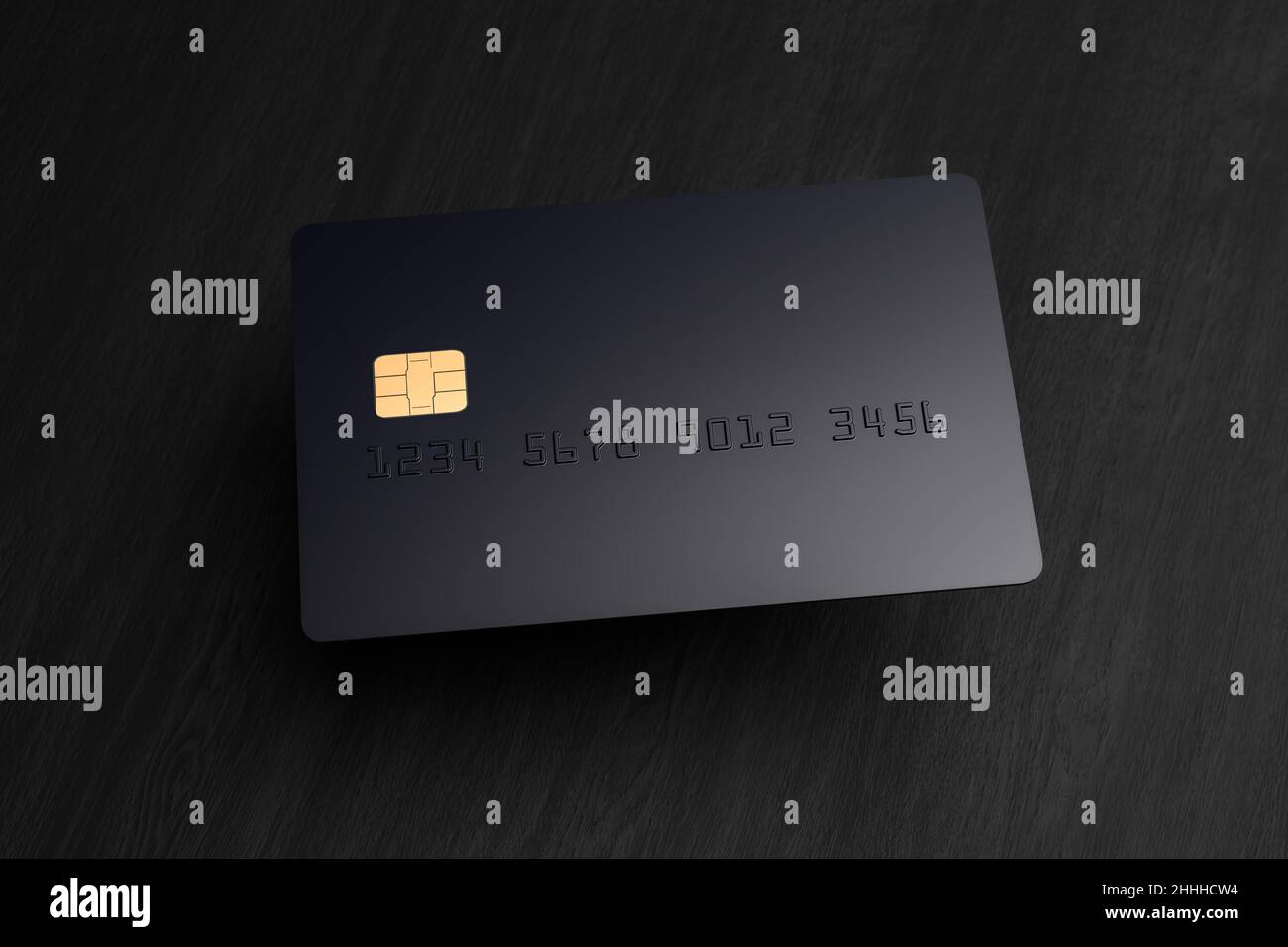 A blank black credit card hovering over a black wood surface with