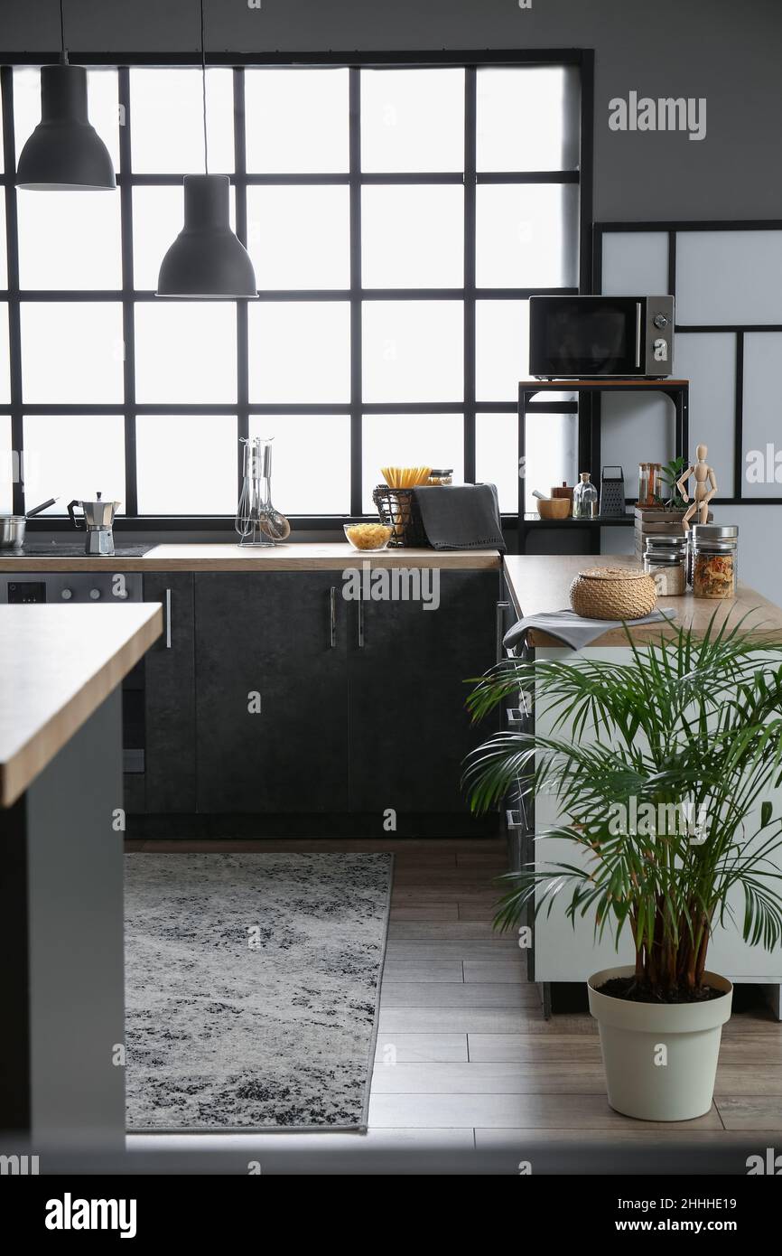 Stylish kitchen with modern furniture, kitchenware and big window Stock ...