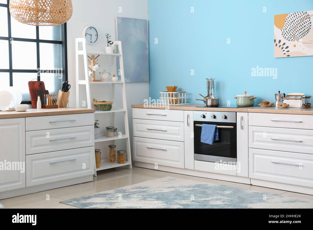 Interior of light modern kitchen with white counters Stock Photo - Alamy