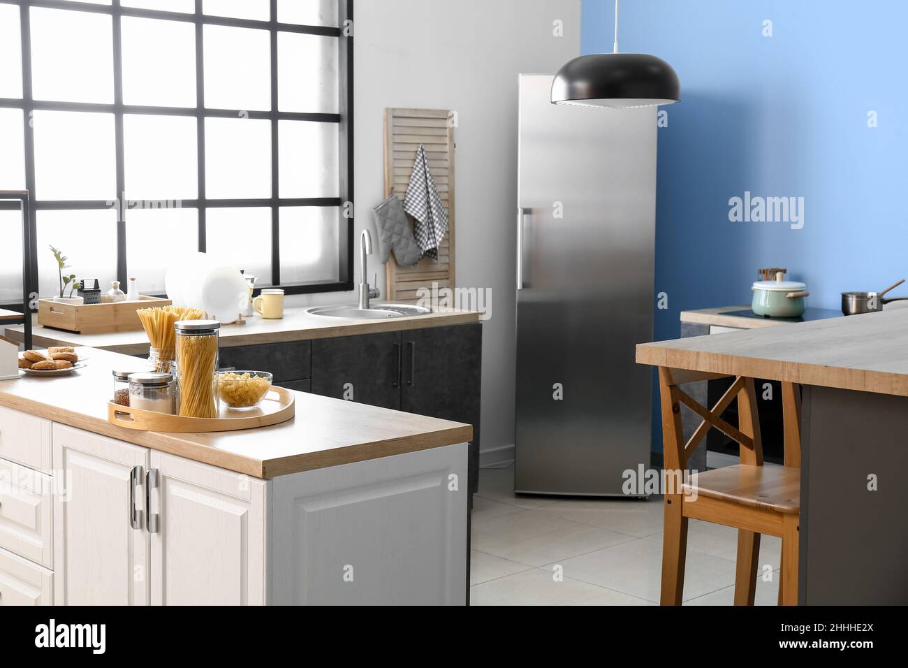 Interior of comfortable kitchen with stylish counters and utensils