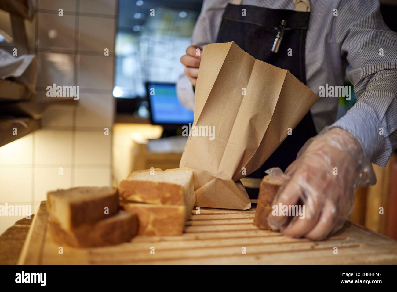 Bakery, bread in paper bag on rustic wood background, grocery concept