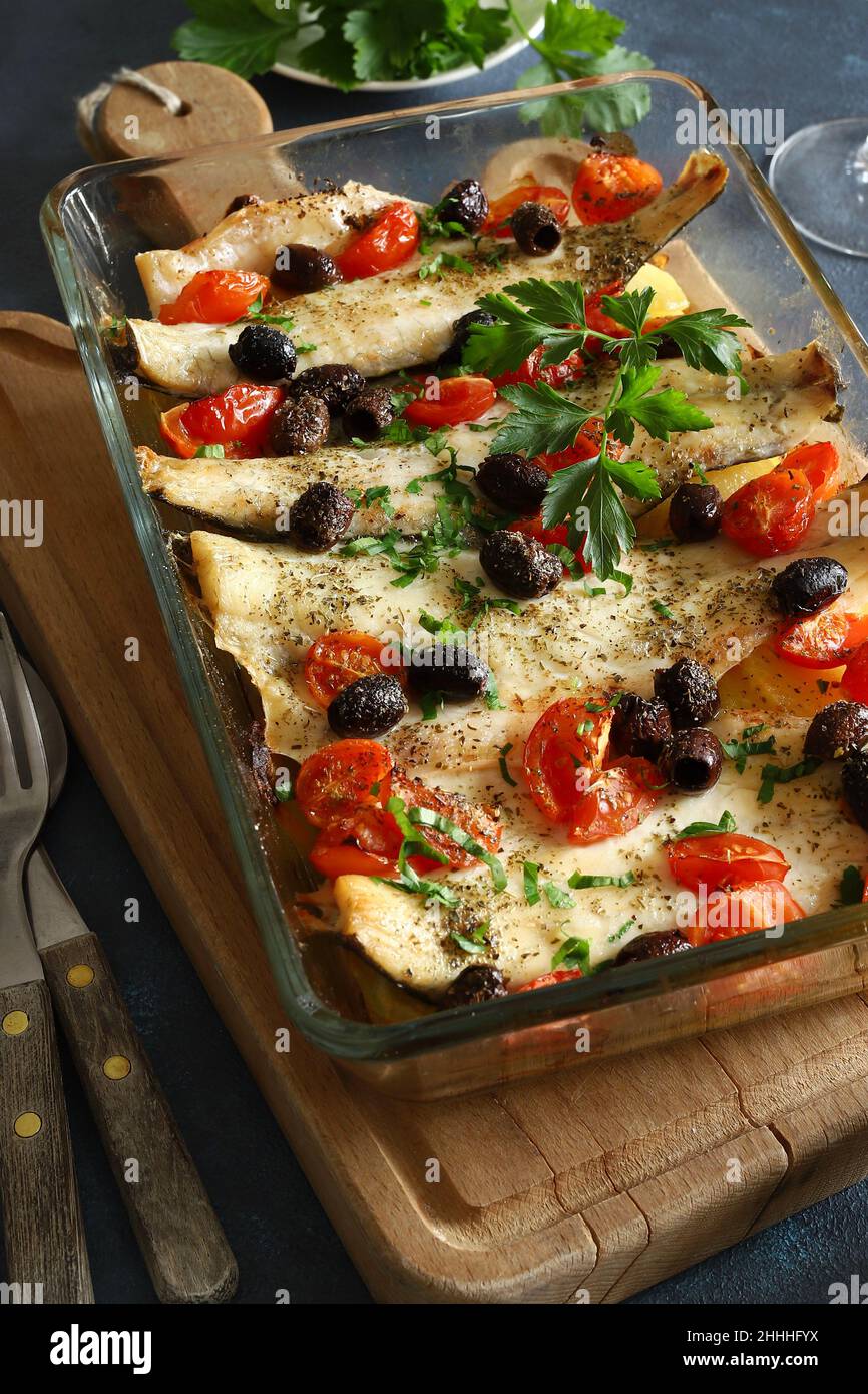Baked sea bass fillets with cherry tomatoes and olives. Directly above