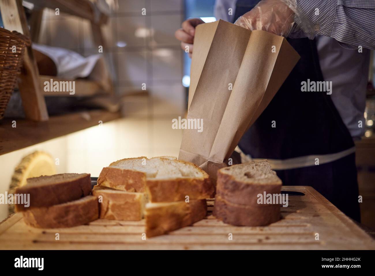 Bakery, bread in paper bag on rustic wood background, grocery concept
