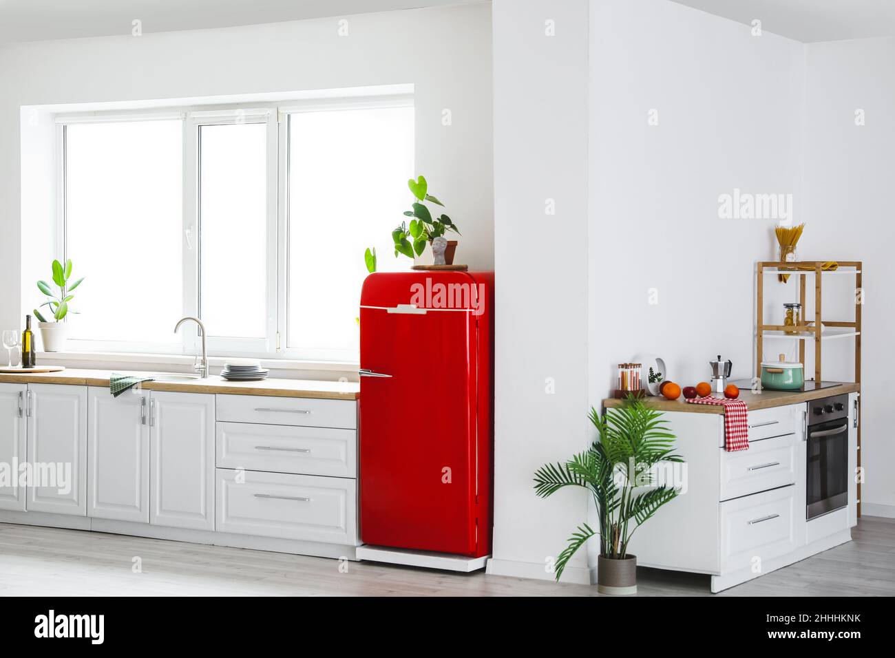 Interior of modern kitchen with stylish refrigerator, counters and ...