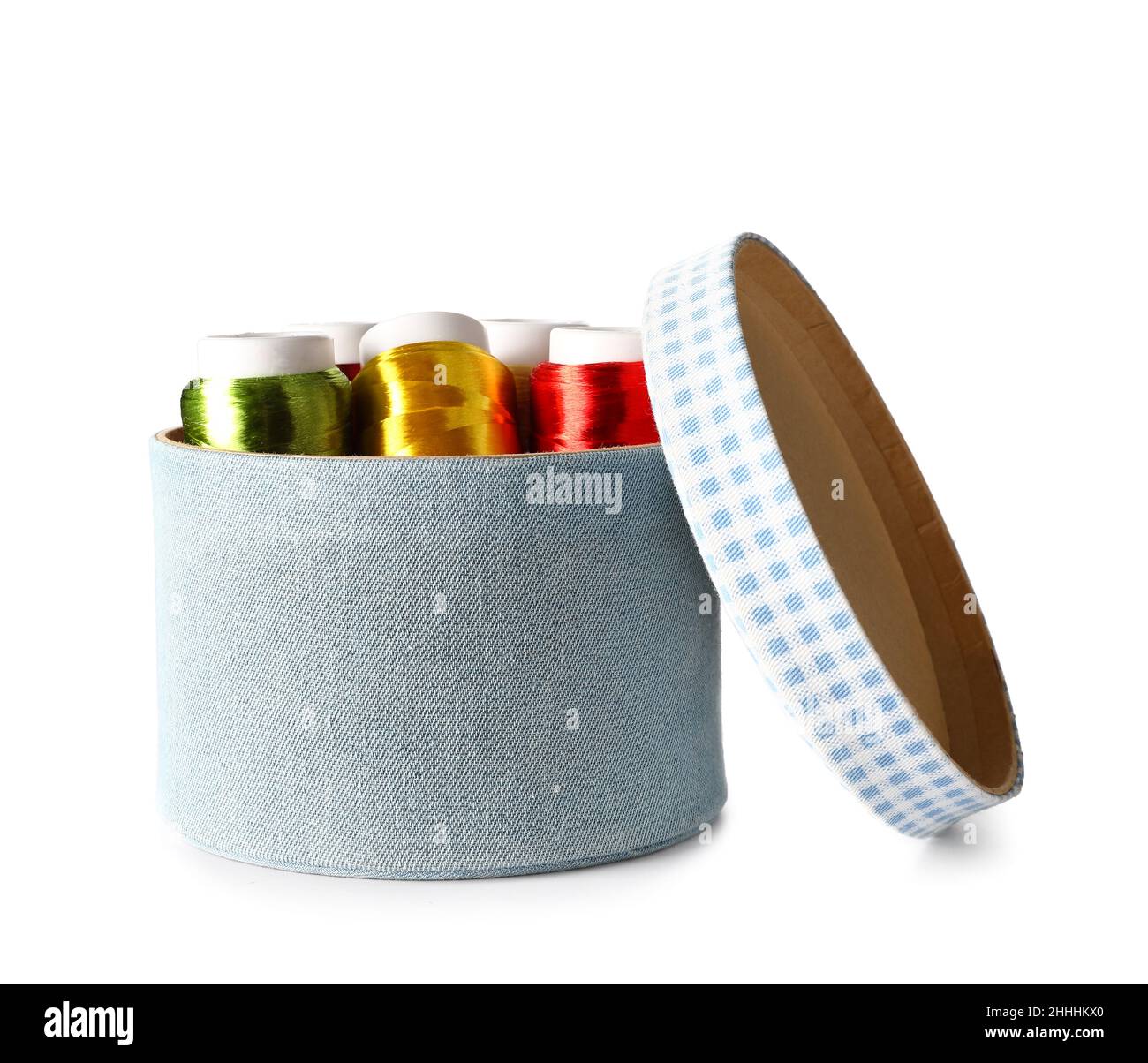 Box with different sewing thread spools on white background Stock Photo
