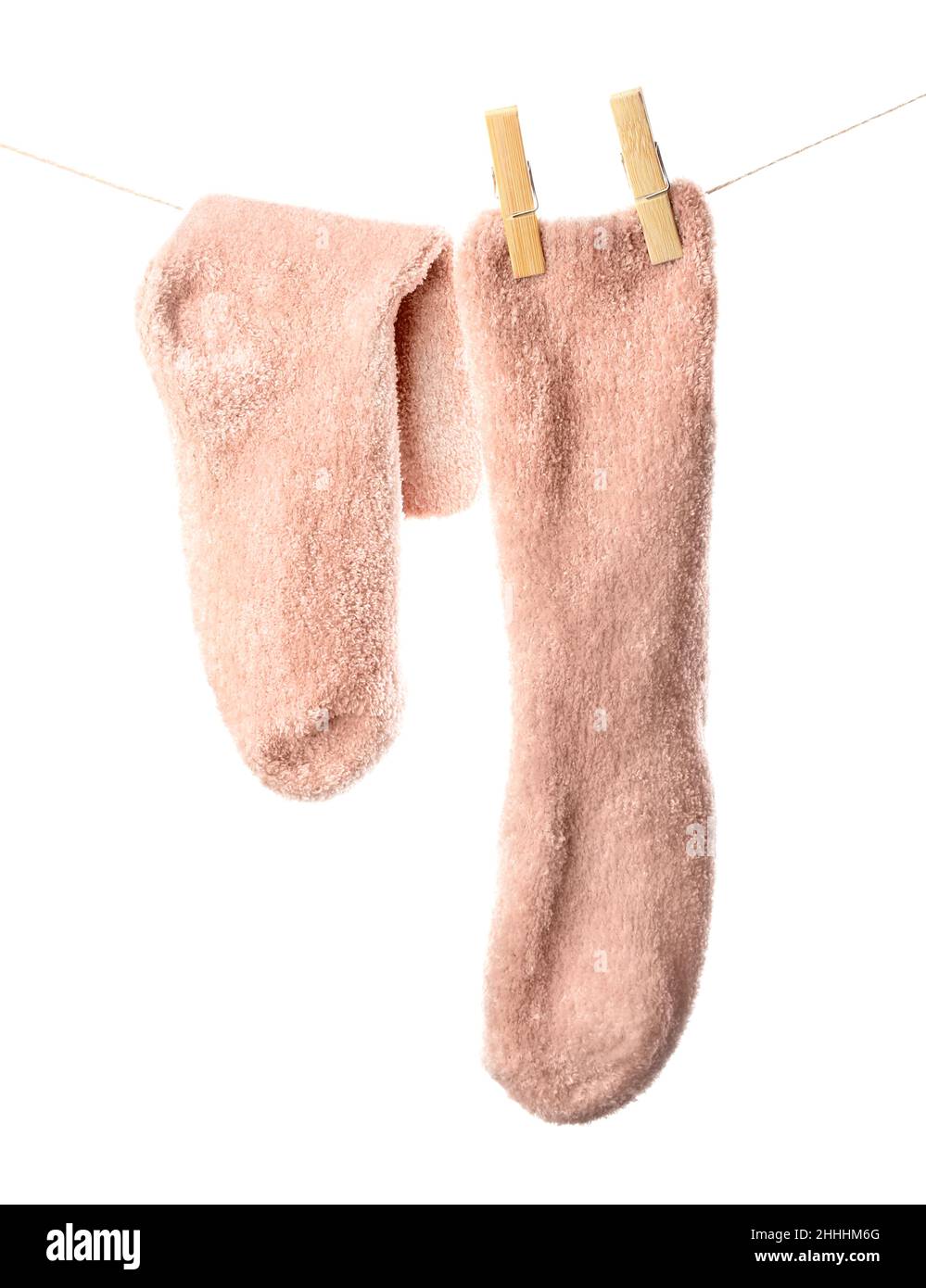 Pair of warm socks hanging on rope against white background, closeup ...