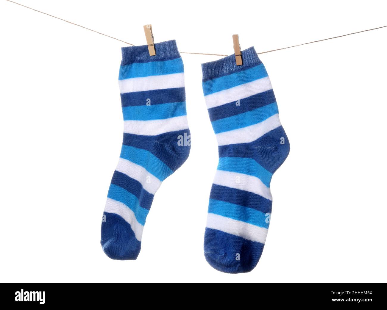 Pair of striped socks hanging on rope against white background Stock ...