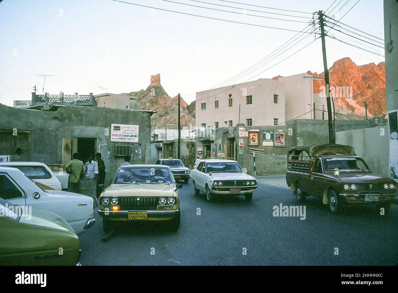 Shops, a watch tower and cars in Muscat, Oman, May 1978 Stock Photo