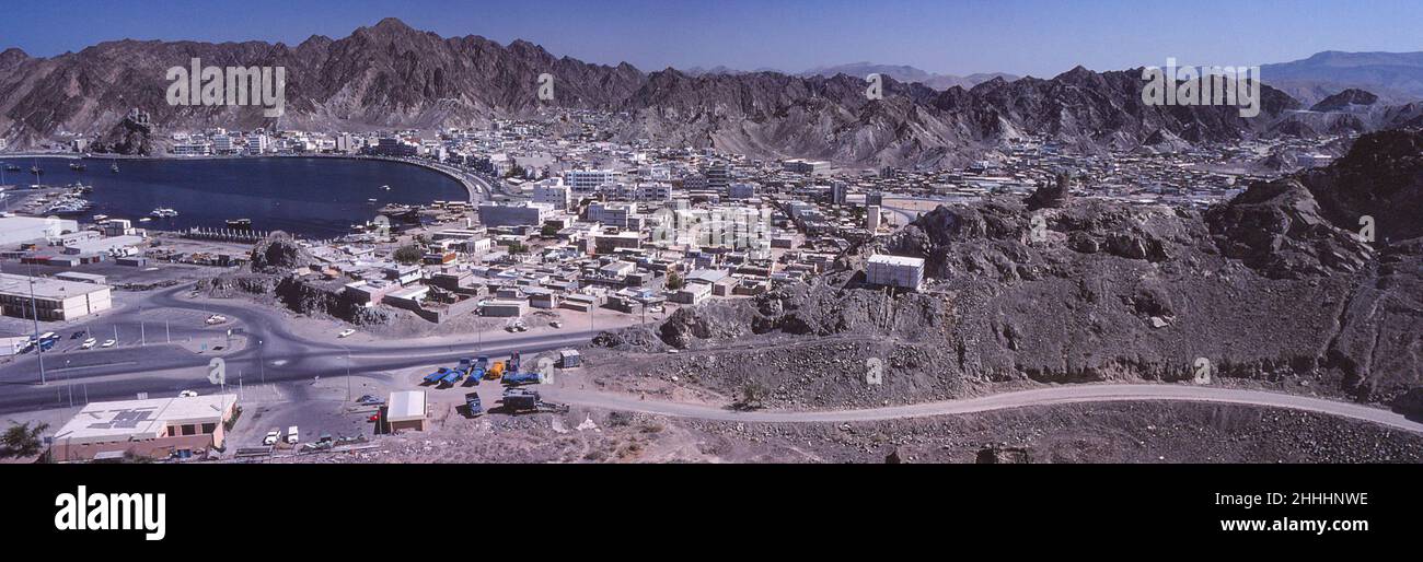 Mutrah town, with part of Port Sultan Qaboos (formerly Mina Qaboos) on left, Mutrah Fort upper left, May 1978 Stock Photo
