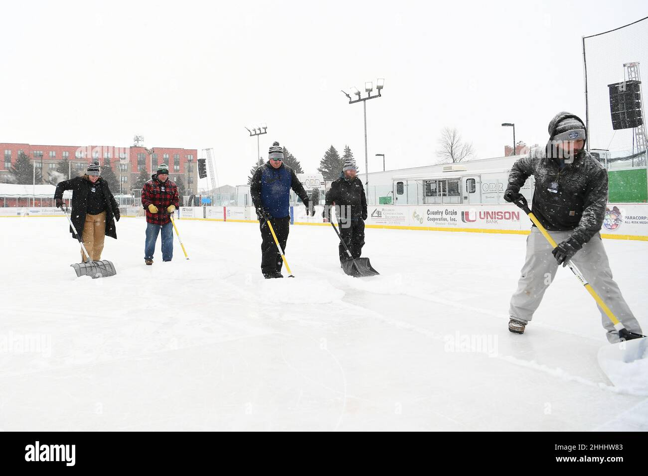 Volunteers clear the ice between games of the 3rd annual Hockey Day North Dakota outdoor hockey event in Jamestown, ND. Youth, high school and college hockey teams from around North Dakota competed over two days. By Russell Hons/CSM Stock Photo