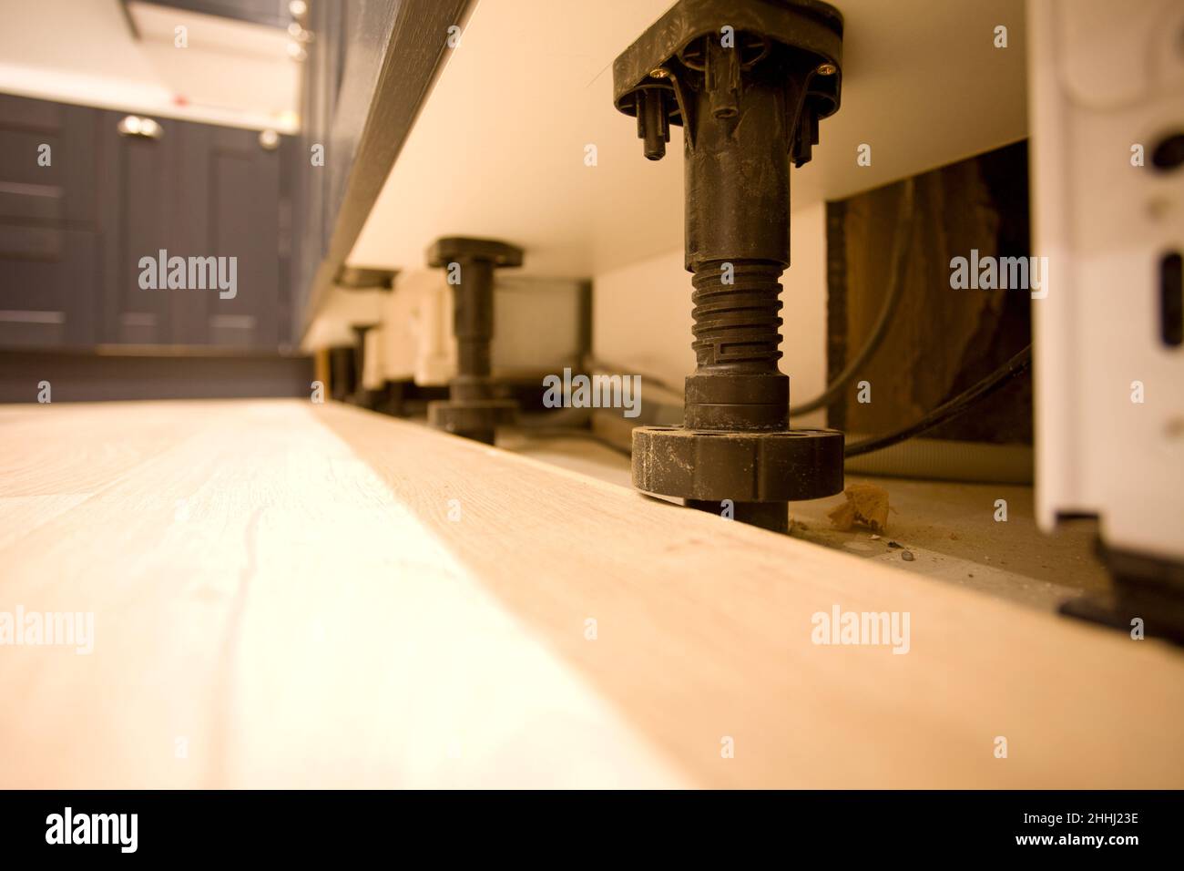 Adjustable plinth feet in kitchen. uk Stock Photo