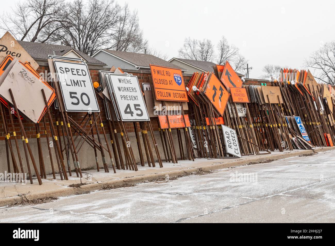 Madison Heights, Michigan - Road signs and barriers for a highway construction project stored along an interstate highway in suburban Detroit. Stock Photo