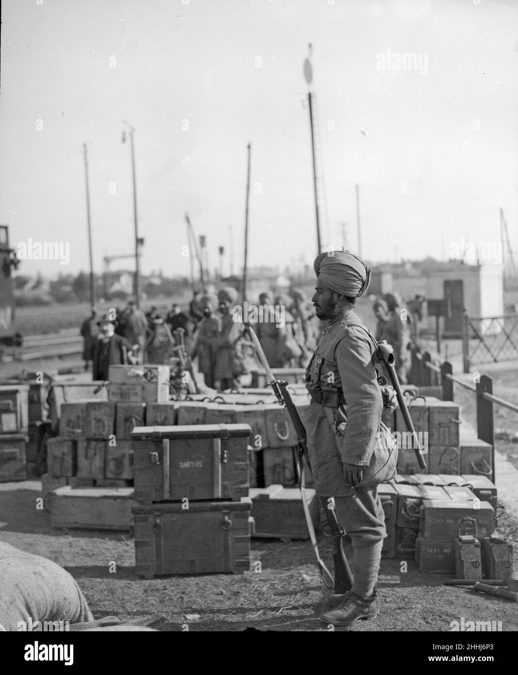 Sentry from the 3rd Lahore Indian Division seen here guarding ammunition boxes at their camp outside Orleans, France. Circa October 1914 Stock Photo