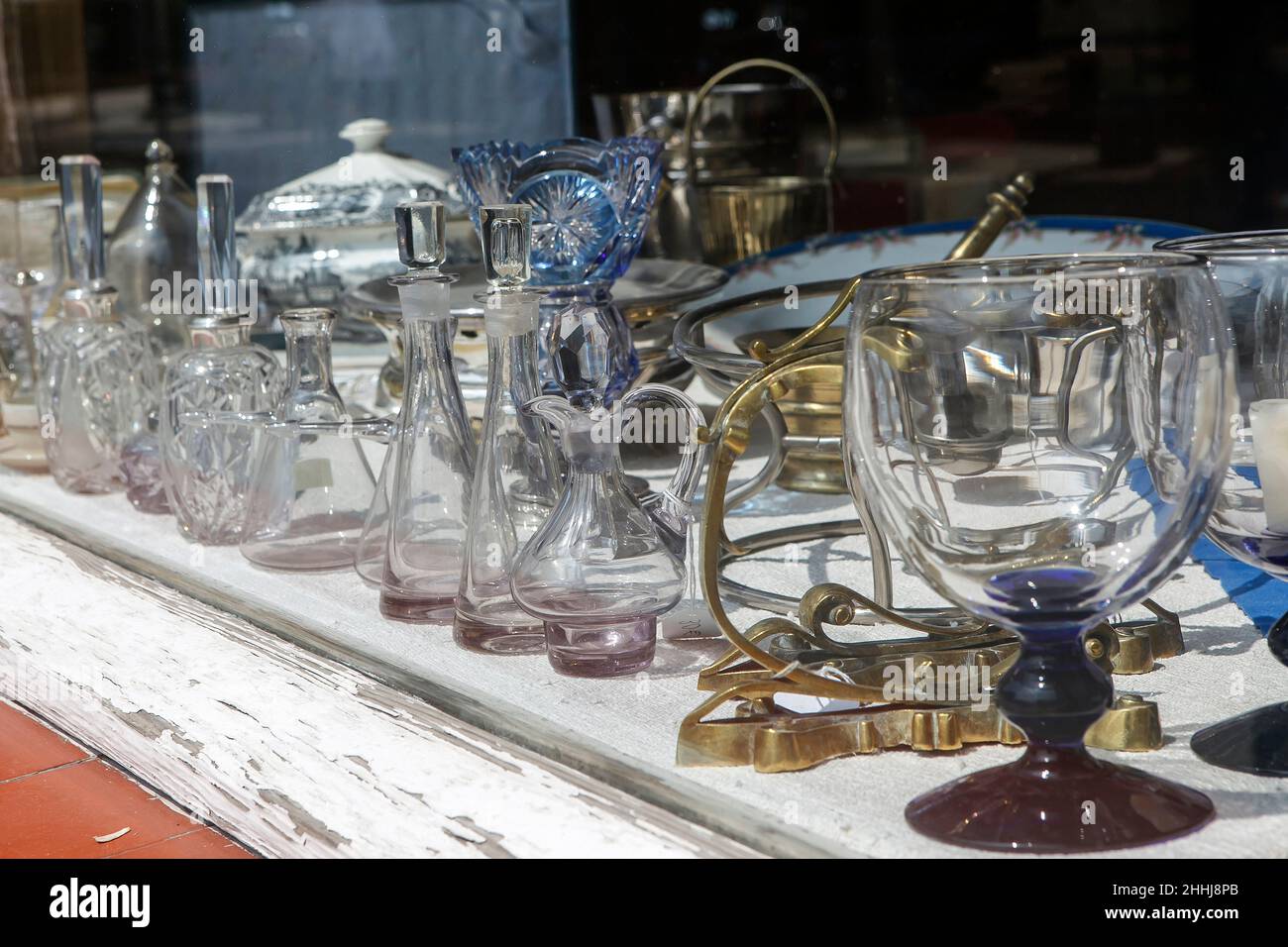 Antique crystal decanters, patterned jugs, glassware, porcelain tureens for flea market sale Stock Photo