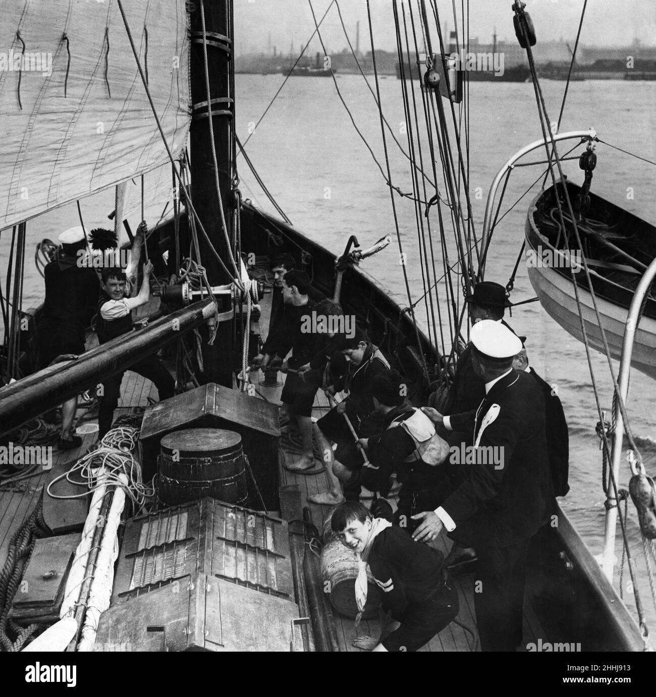 Sea Scouts hard at work on board the vessel given to them by The Daily Mirror. September 1912. Stock Photo