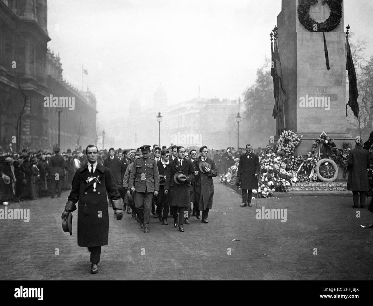 Soldiers active and de-mobbed march pass the cenotaph in Whitehall on the first anniversary of Armistice Day. 11th November 1919 Stock Photo