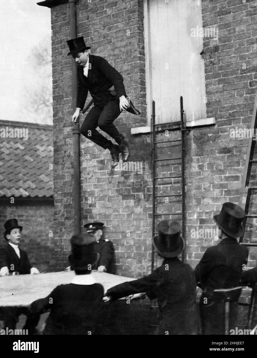 Eton boys firemen. Charles Duncombe, 3rd Earl of Feversham, jumps into a life saving sheet. Windsor, Berkshire. 22nd February 1921. Stock Photo