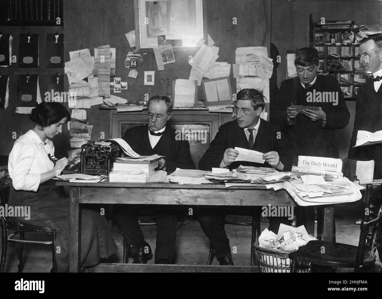 Irish trade Union leader and social activist James Larkin pictured in his office at liberty hall in Dublin with his typist and secretary Mrs McKeon perusing a mass of correspondance, dealing with transport and other matters left in absence during his imprisonment.Picture taken during the Dublin lockout, a major industrial dispute between 20000 workers and 300 employers between August 1913 and January 1914. Taken: 16th November 1913. Stock Photo