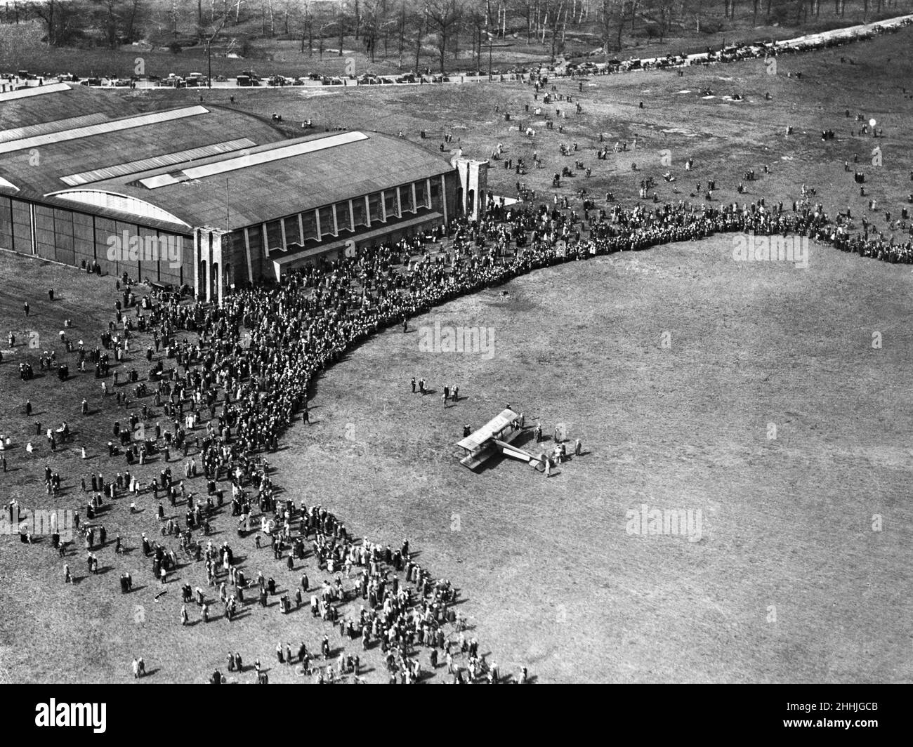 An Avro 504K three seater bi plane draws a huge crowds as it makes a landing at Alexandra Park Aerodrome in Manchester.June 1920. Stock Photo