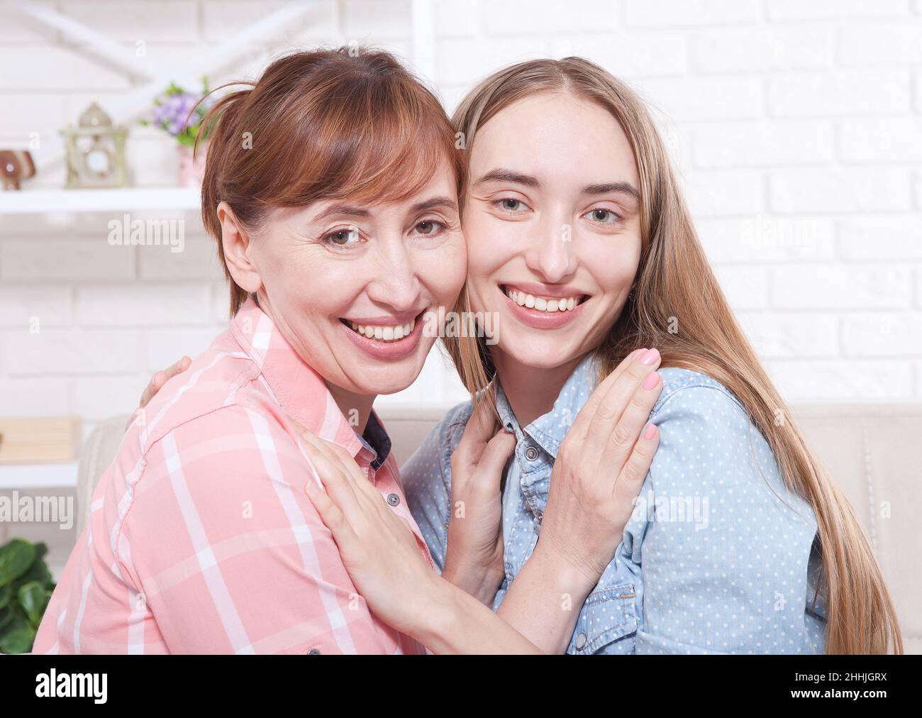 Mother and daughter at home background. Smiling women. Early pregnancy. Mother day Stock Photo