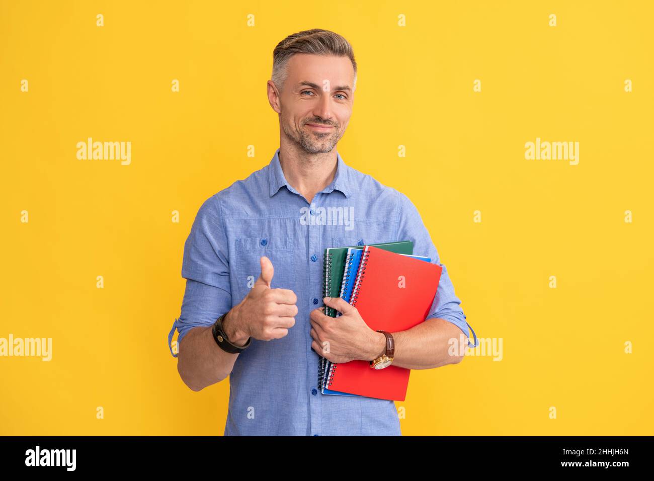 happy man hold school notebook or planner showing thumb up, education Stock Photo