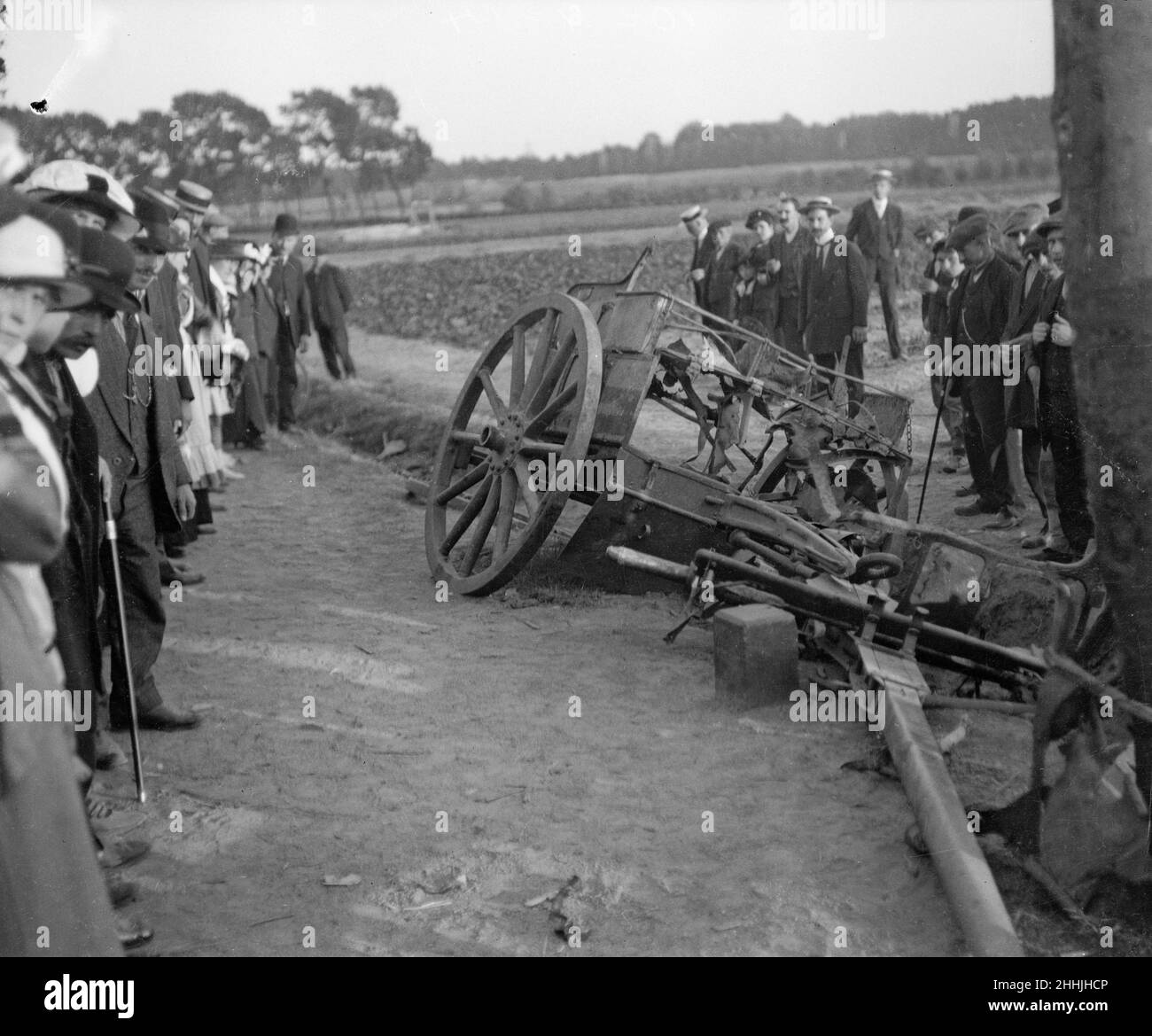 Locals examine a damaged and abandoned gun limber in the remains of the Belgium village of Melle Circa September 1914 Stock Photo