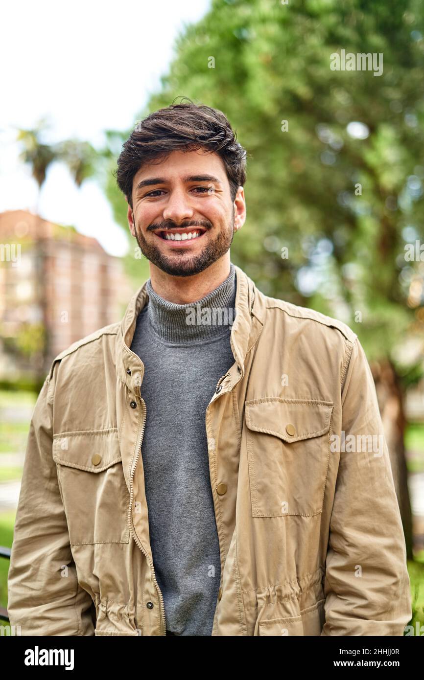 Happy bearded man in casual turtleneck and jacket cheerfully smiling at ...