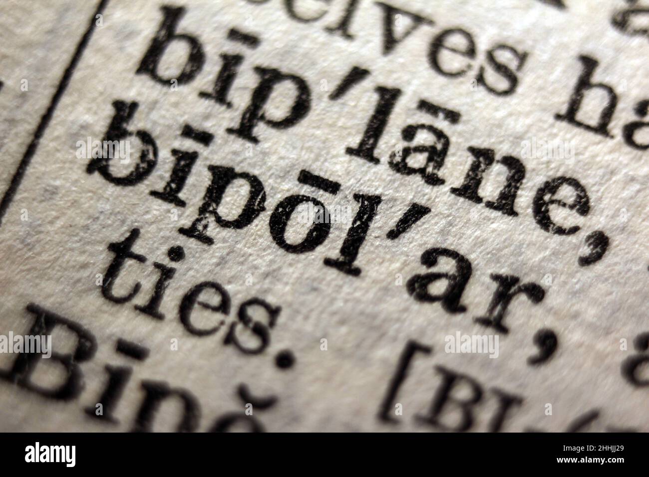 Word 'bipolar' printed on dictionary page, macro close-up Stock Photo