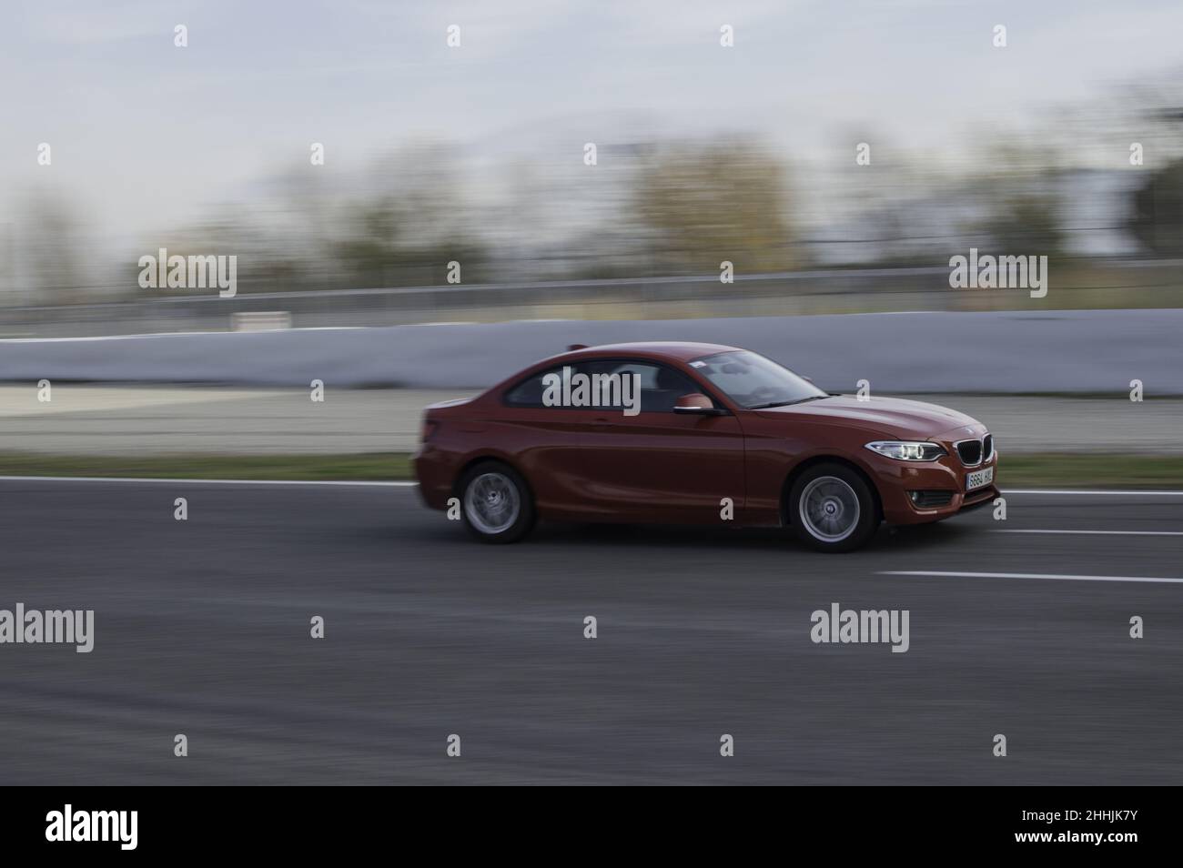 Red BMW 2 Series driving on a racing circuit in Barcelona, Spain Stock ...