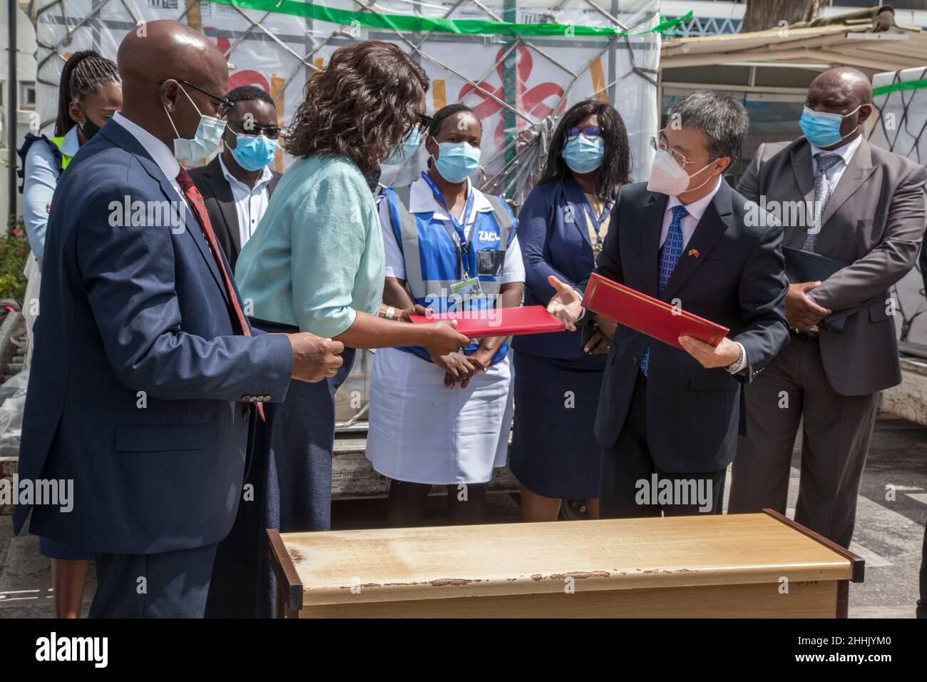 Lusaka, Zambia. 24th Jan, 2022. Zambian Health Minister Sylvia Masebo (2nd L, Front) and Chinese Ambassador to Zambia Li Jie (1st R, Front) attend a ceremony for the arrival of China-donated COVID-19 vaccines at the Kenneth Kaunda International Airport in Lusaka, Zambia, on Jan. 24, 2022. Zambia on Monday received a fresh batch of COVID-19 vaccines donated by the Chinese government. Credit: Martin Mbangweta/Xinhua/Alamy Live News Stock Photo