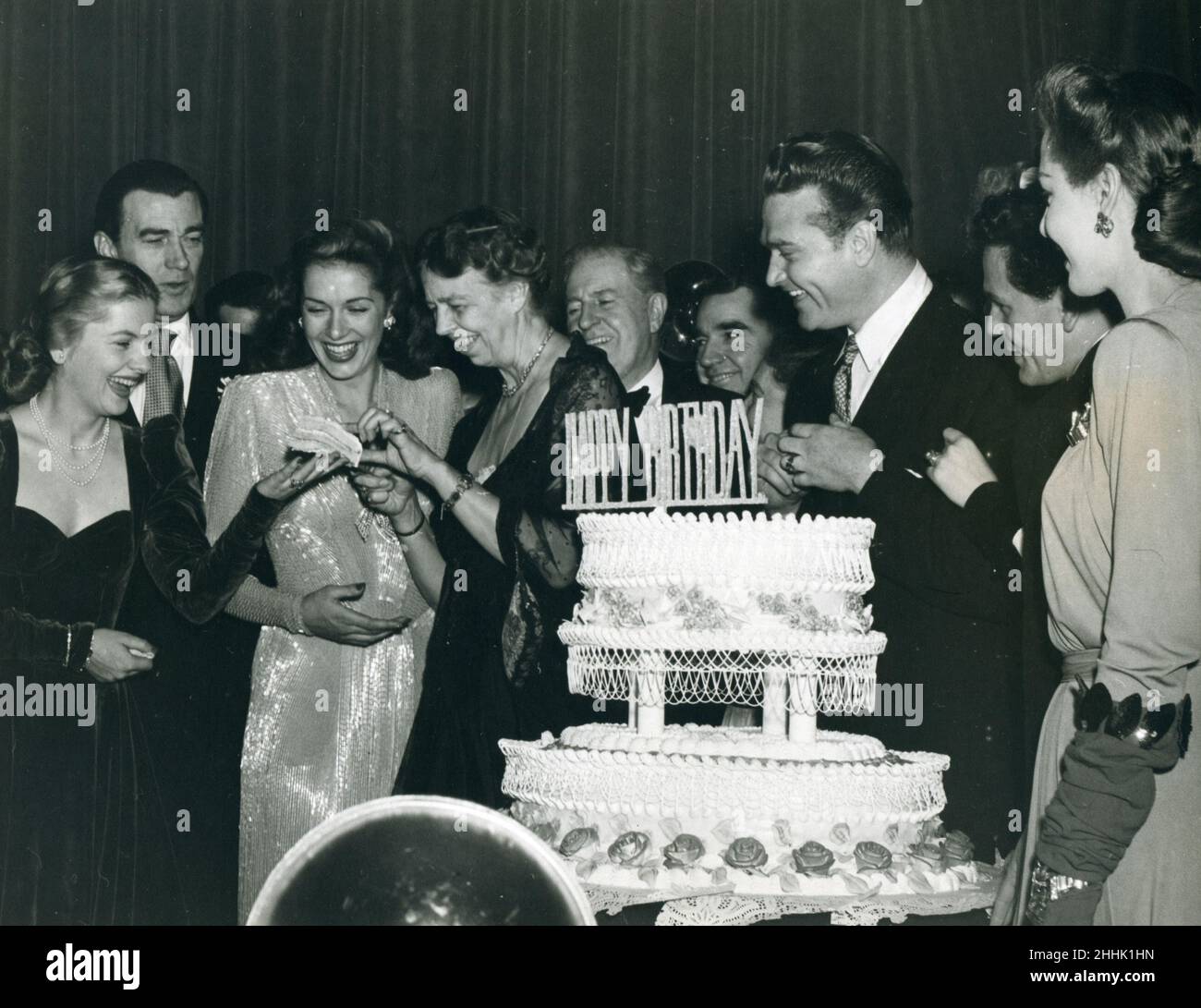 Washington, DC -- FDR's Birthday Celebration at the Statler Hotel, January 29, 1944. First Lady Eleanor Roosevelt gives actress Joan Fontaine a piece of birthday cake as comedian Red Skelton, actor John Garfield and others look on. Photo: Abbie Rowe Stock Photo