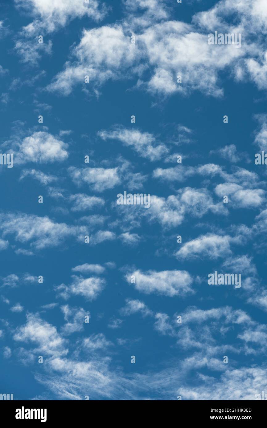 Puffy white clouds in blue sky Stock Photo - Alamy