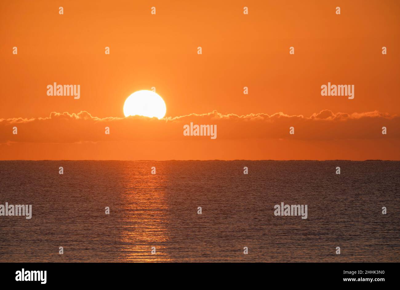 Blazing sunrise in orange sky over ocean Stock Photo - Alamy