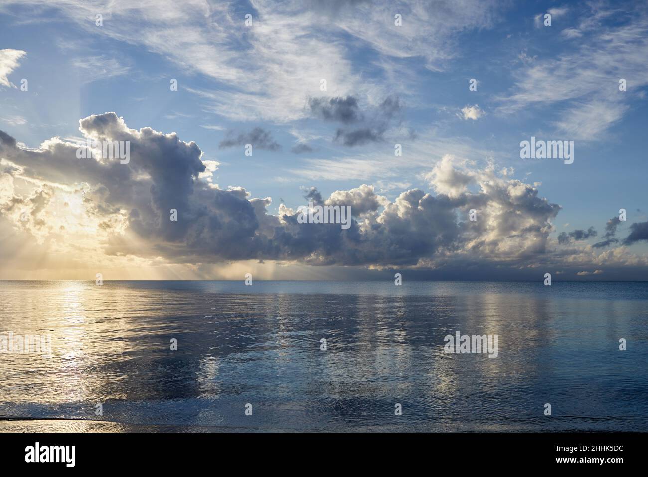 Clouds over ocean at sunrise Stock Photo - Alamy