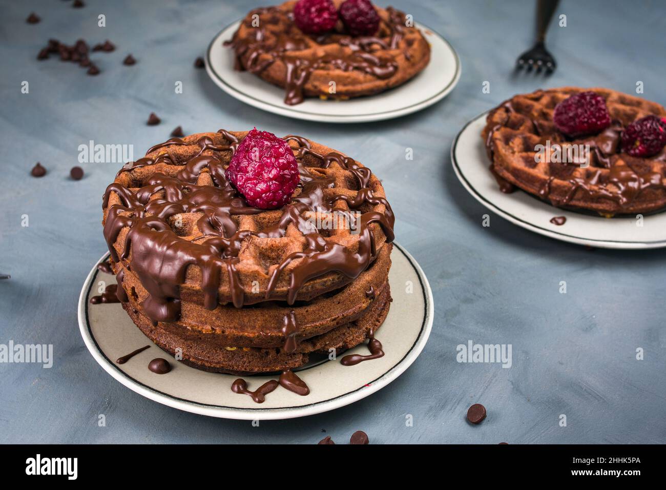 From above tasty sweet waffles topped with chocolate sauce and ...