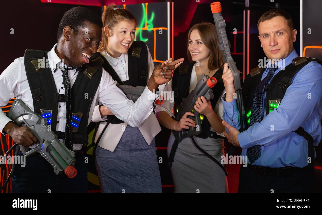 Group of young coworkers holding laser guns Stock Photo Alamy
