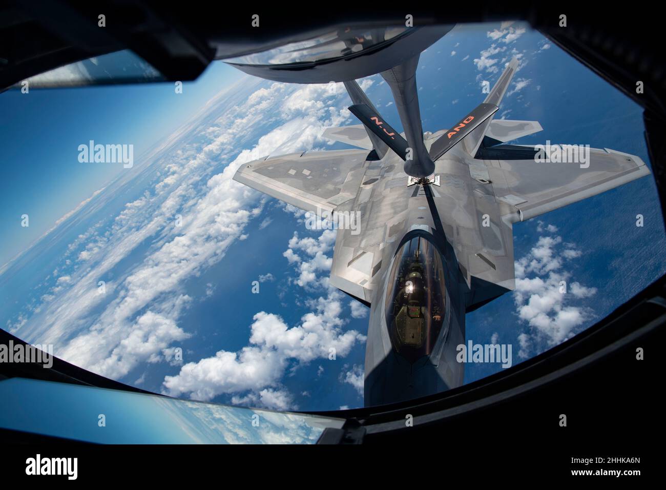 A Hawaii Air National Guard F-22 Raptor is refueled by a New Jersey Guard KC-135R Stratotanker during Sentry Aloha, August 16, 2021, above the Pacific ocean near Hawaii. Sentry Aloha '21 is a three-week exercise, hosted by the Hawaii Air National Guard's 154th Wing, that provides pilots, aircrew, and maintainers, from the Total Force, with realistic combat training through a series of flight missions. (U.S. Air National Guard photo by Senior Airman Andrea A. S. Williamson) Stock Photo
