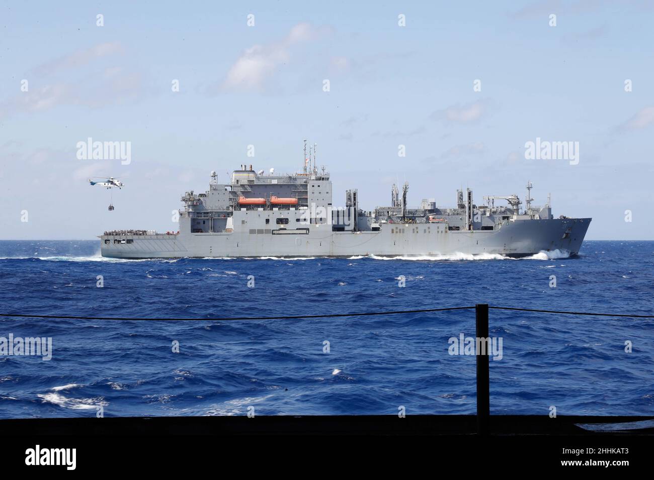 PHILIPPINE SEA (Jan. 20, 2022) The Military Sealift Command dry cargo and ammunition ship USNS Matthew Perry (T-AKE 9) sails alongside USS Abraham Lincoln (CVN 72) during a replenishment-at-sea. Operating as part of U.S. Pacific Fleet, Abraham Lincoln is conducting training to preserve and protect a free and open Indo-Pacific region. (U.S. Navy photo by Mass Communication Specialist Seaman Apprentice Jett Morgan) Stock Photo