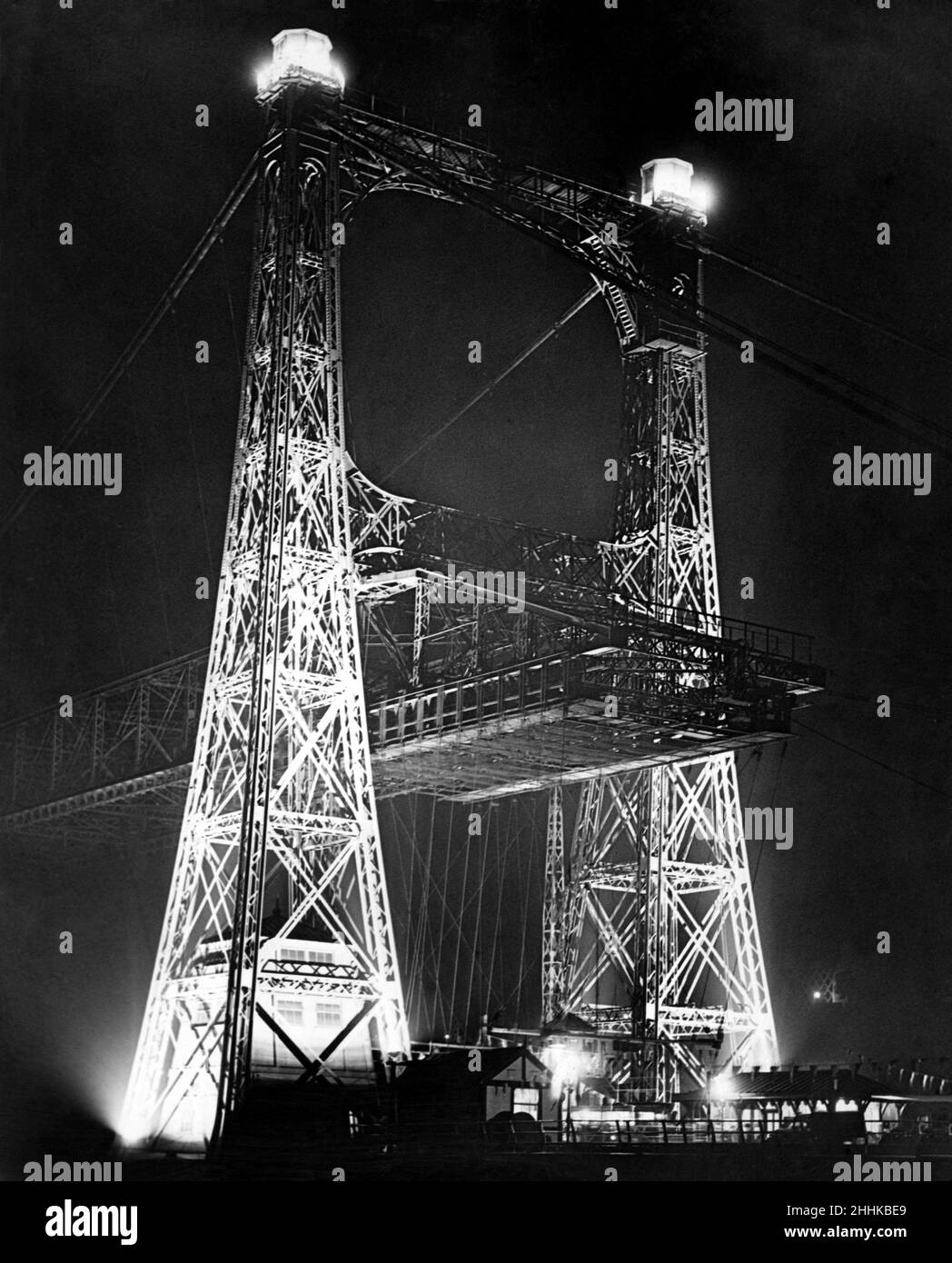 The Widnes-Runcorn Transporter Bridge, by floodlight, which links Widnes and Runcorn. It was lit by floodlight as part of the celebrations for the silver jubilee of King George V. May 1935. Stock Photo