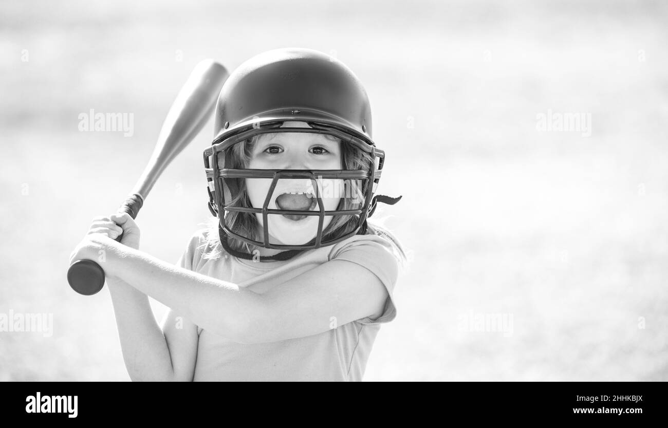 Portrait of excited kid baseball player wearing helmet and hold baseball bat. Stock Photo