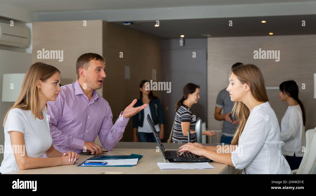Man and two women having meeting Stock Photo - Alamy