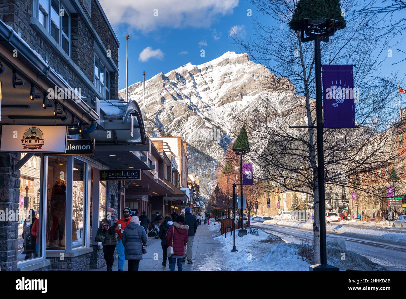 Banff, Alberta, Canada - January 23 2022 : Tourists shopping on Banff Avenue in winter during covid-19 pandemic period. Stock Photo