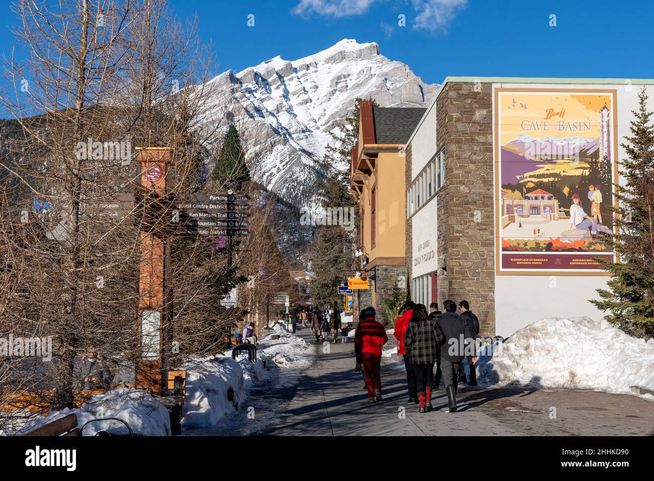 Banff, Alberta, Canada - January 23 2022 : Tourists shopping on Banff Avenue in winter during covid-19 pandemic period. Stock Photo