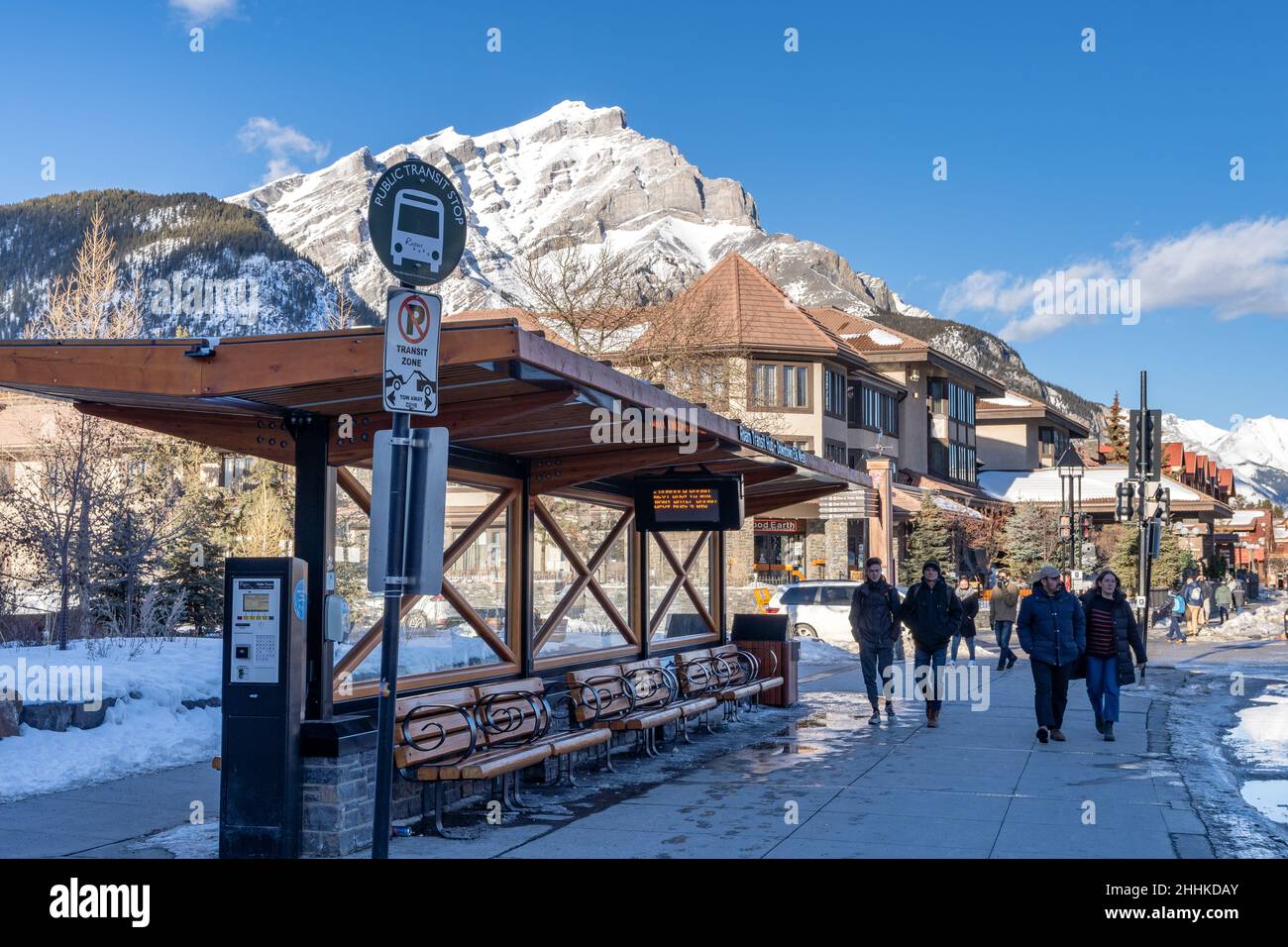Street view of Town of Banff. Bus stop on Banff Avenue in winter snowy season. Banff, Alberta, Canada. Stock Photo