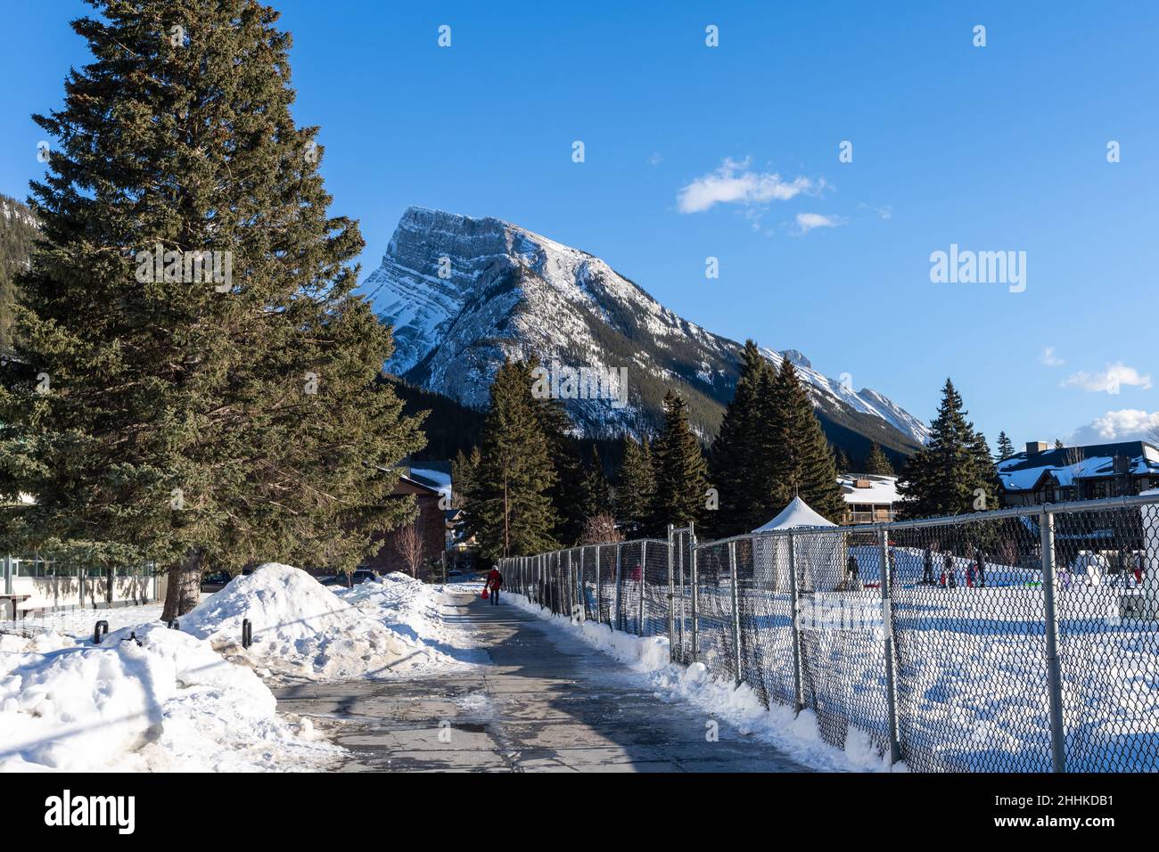 Town of Banff in a winter sunny day. Snowcapped Mount Rundle in the background. Stock Photo