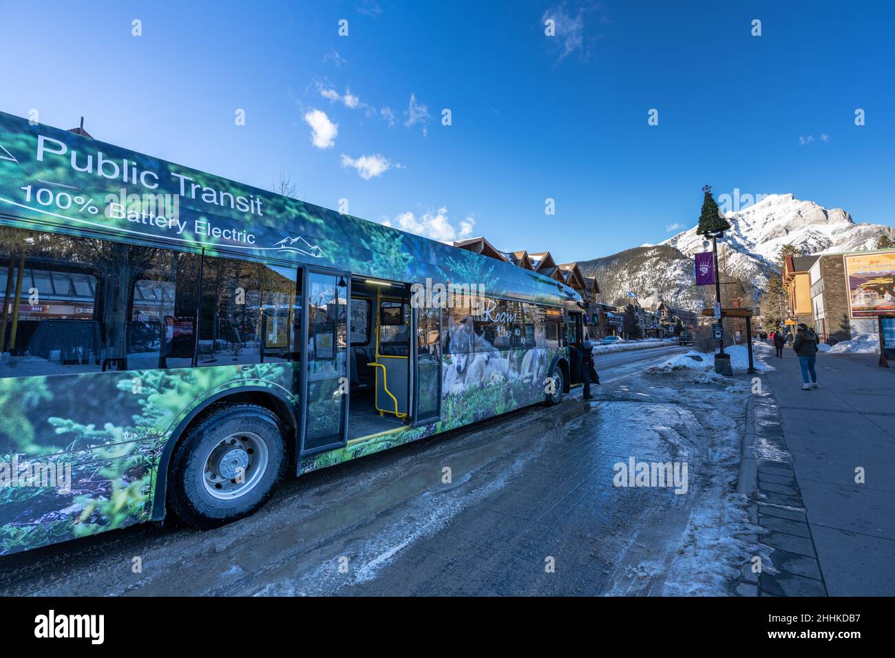 Street view of Town of Banff. Bus stop on Banff Avenue in winter snowy season. Banff, Alberta, Canada. Stock Photo