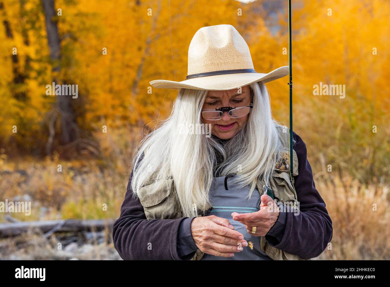 USA, Idaho, Bellevue, Senior woman putting bait on fishing rod Stock Photo