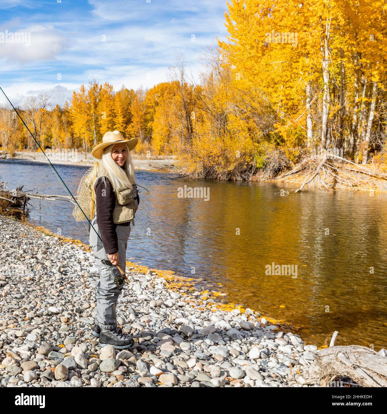 USA, Idaho, Bellevue, Portrait of senior woman fly-fishing in Big Wood River in autumn Stock Photo