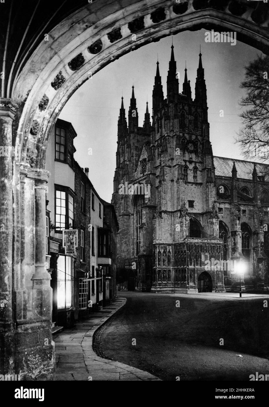 Canterbury Cathedral in Canterbury in Kent England.Canterbury is a historic cathedral city in Kent, southeast England, on the River Stour. The city is the metropolis of the Anglican Communion and seat of the archbishop of Canterbury Cathedral gate flanked by two towers viewed through archway. Circa 1935 Stock Photo