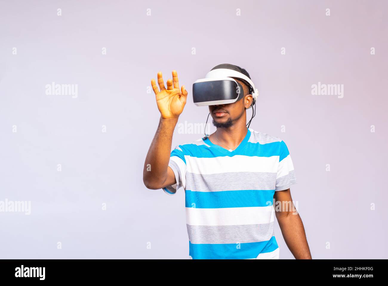 Portrait Of a young african Man Wearing Virtual Reality Glasses Against ...